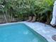 Inviting backyard pool with a lounge chairs, surrounded by lush tropical landscaping at 4912 W Dryad St, Tampa, FL 33629