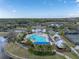 The aerial view highlights the community pool, clubhouse, tennis courts, and lush landscaping at 4958 Southern Valley Loop, Brooksville, FL 34601