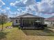 Backyard featuring a covered, screened-in patio, perfect for outdoor entertaining and relaxation at 4958 Southern Valley Loop, Brooksville, FL 34601