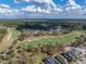 An aerial view captures the community's expansive golf course with meticulously manicured greens and fairways at 4958 Southern Valley Loop, Brooksville, FL 34601