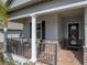 Inviting porch features brick flooring, decorative wreath, and ample seating for relaxing at 4958 Southern Valley Loop, Brooksville, FL 34601