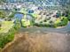 Aerial view of the waterway showcasing the private dock with a boat, a bridge, waterfront views, and community charm at 504 S Florida Ave # 225, Tarpon Springs, FL 34689