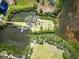 Overhead aerial shot shows a private dock with a boat and a scenic bridge leading to a beautiful waterfront property at 504 S Florida Ave # 225, Tarpon Springs, FL 34689