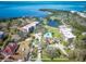 Aerial view of a waterfront neighborhood with a shared swimming pool, residences, landscaping and bay at 504 S Florida Ave # 225, Tarpon Springs, FL 34689