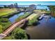 Stunning aerial view of a dock with a boat, a bridge, and lush greenery, highlighting waterfront living at 504 S Florida Ave # 225, Tarpon Springs, FL 34689