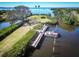 Close aerial view of the dock with a boat with waterfront access and lush landscaping in this community at 504 S Florida Ave # 225, Tarpon Springs, FL 34689
