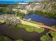 Aerial view showcasing waterfront property with private dock, boat, and a picturesque bridge surrounded by nature at 504 S Florida Ave # 225, Tarpon Springs, FL 34689