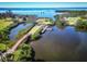Expansive aerial view featuring a private dock, boat, picturesque bridge, and serene waterfront at 504 S Florida Ave # 225, Tarpon Springs, FL 34689