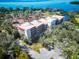 Aerial view of a apartment building with green landscaping surrounding at 504 S Florida Ave # 225, Tarpon Springs, FL 34689