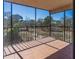 A screened-in balcony with tiled flooring, providing a scenic view of the surrounding landscape at 504 S Florida Ave # 225, Tarpon Springs, FL 34689