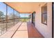 View from the tiled balcony, featuring screen enclosure, metal railing, and golf course view beyond at 504 S Florida Ave # 225, Tarpon Springs, FL 34689