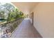 Tiled balcony with decorative wrought iron railings offers outdoor relaxation and views of the greenery at 504 S Florida Ave # 225, Tarpon Springs, FL 34689