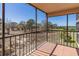 A screened-in balcony featuring tile floor and a metal railing showcasing the trees in the distance at 504 S Florida Ave # 225, Tarpon Springs, FL 34689