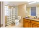 Bathroom featuring tiled walls, glass block shower, granite topped vanity and a toilet at 504 S Florida Ave # 225, Tarpon Springs, FL 34689