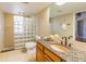 Bathroom featuring tiled walls, glass block shower, granite topped vanity and a toilet at 504 S Florida Ave # 225, Tarpon Springs, FL 34689