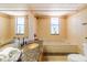 Bright bathroom with a large soaking tub, granite countertop vanity, and natural light at 504 S Florida Ave # 225, Tarpon Springs, FL 34689