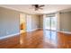 Bedroom featuring hardwood floors, ceiling fan, and sliding glass doors to the balcony at 504 S Florida Ave # 225, Tarpon Springs, FL 34689
