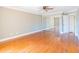 Bedroom featuring hardwood floors, ceiling fan, and a mirrored closet for a stylish look at 504 S Florida Ave # 225, Tarpon Springs, FL 34689