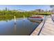 Waterfront dock with boat slip; serene view of the canal and surrounding condo buildings at 504 S Florida Ave # 225, Tarpon Springs, FL 34689
