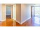 Bright hallway featuring wood floors, access to rooms, and an opening to a balcony with natural light at 504 S Florida Ave # 225, Tarpon Springs, FL 34689