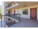 View of an exterior hallway featuring multiple doors and decorative metal railings at 504 S Florida Ave # 225, Tarpon Springs, FL 34689