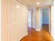 Hallway featuring closets, wood floors, and natural lighting from the doorway at 504 S Florida Ave # 225, Tarpon Springs, FL 34689