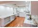 Spacious open kitchen with white cabinets, granite counters, modern appliances and hardwood floors at 504 S Florida Ave # 225, Tarpon Springs, FL 34689