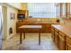 Well-lit kitchen with wooden cabinetry, ample counter space, and tiled flooring at 504 S Florida Ave # 225, Tarpon Springs, FL 34689