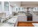 Bright kitchen featuring white cabinets, stone countertops, stainless steel appliances and hardwood floors at 504 S Florida Ave # 225, Tarpon Springs, FL 34689