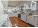Well-lit kitchen showcasing white cabinets, marble countertops, stainless steel appliances, and hardwood flooring at 504 S Florida Ave # 225, Tarpon Springs, FL 34689