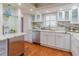 Bright kitchen features white cabinets, marble counters, stainless steel appliances, and hardwood floors at 504 S Florida Ave # 225, Tarpon Springs, FL 34689
