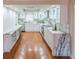 Bright and airy kitchen featuring white cabinets, stone counters, modern appliances and hardwood floors at 504 S Florida Ave # 225, Tarpon Springs, FL 34689