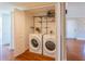 Convenient laundry room with a full-size washer, dryer, and storage shelving for organized living at 504 S Florida Ave # 225, Tarpon Springs, FL 34689