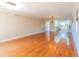 Large living room with hardwood floors, light fixtures, kitchen access, and a large window at 504 S Florida Ave # 225, Tarpon Springs, FL 34689