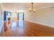Spacious living room with hardwood floors, fireplace, light fixture and a large window at 504 S Florida Ave # 225, Tarpon Springs, FL 34689