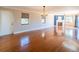 Spacious living room with hardwood floors, fireplace, light fixture and a large window at 504 S Florida Ave # 225, Tarpon Springs, FL 34689