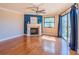 Bright living room features hardwood floors, ceiling fan, fireplace and sliding glass doors to a balcony at 504 S Florida Ave # 225, Tarpon Springs, FL 34689
