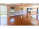 Spacious living room with hardwood floors, fireplace, light fixture and a large window at 504 S Florida Ave # 225, Tarpon Springs, FL 34689