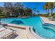 Expansive pool with wading area and spa surrounded by patio and lounge chairs for ultimate relaxation at 504 S Florida Ave # 225, Tarpon Springs, FL 34689
