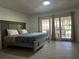 Relaxing bedroom with a king-sized bed and French doors leading to a private outdoor patio at 5144 Pine Tree Ln, Wesley Chapel, FL 33543