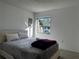 Bright bedroom features a large window offering neighborhood views and plush bedding at 5144 Pine Tree Ln, Wesley Chapel, FL 33543