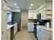Bright kitchen featuring white cabinets, stainless steel appliances, and modern countertops at 5144 Pine Tree Ln, Wesley Chapel, FL 33543
