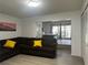 Cozy living room leading to bedroom with neutral walls and comfortable seating at 5144 Pine Tree Ln, Wesley Chapel, FL 33543