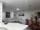 Inviting living room featuring a large comfortable sofa, complemented by modern decor and lots of light at 5144 Pine Tree Ln, Wesley Chapel, FL 33543