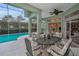 Outdoor patio featuring a view of a swimming pool, patio furniture, and a ceiling fan at 5501 Stag Thicket Ln, Palm Harbor, FL 34685