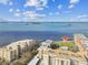 Scenic aerial view of condo buildings on the waterfront with a pier and multiple docks at 620 Edgewater Dr # 204, Dunedin, FL 34698