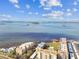 Elevated view of condo buildings near water with docks, piers, and islands in the distance at 620 Edgewater Dr # 204, Dunedin, FL 34698