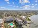 Elevated view of condo building, surrounding residential area, and a river in the distance at 620 Edgewater Dr # 204, Dunedin, FL 34698