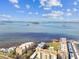 Fantastic aerial view of condo community on the bay, with dock, a community clubhouse, and waterfront access at 620 Edgewater Dr # 204, Dunedin, FL 34698