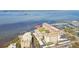 Elevated view of waterfront condo buildings with boat docks and a scenic coastline at 620 Edgewater Dr # 204, Dunedin, FL 34698